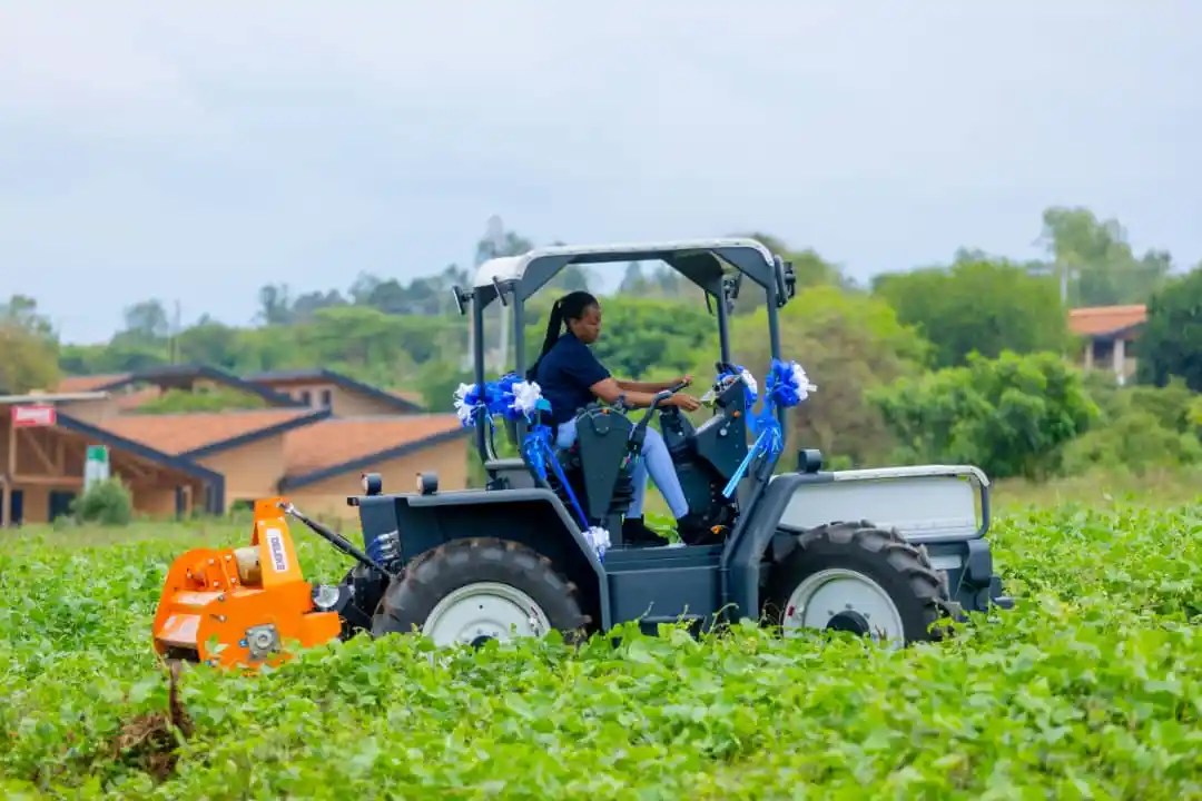 Lady using VW electric tractor in a field
