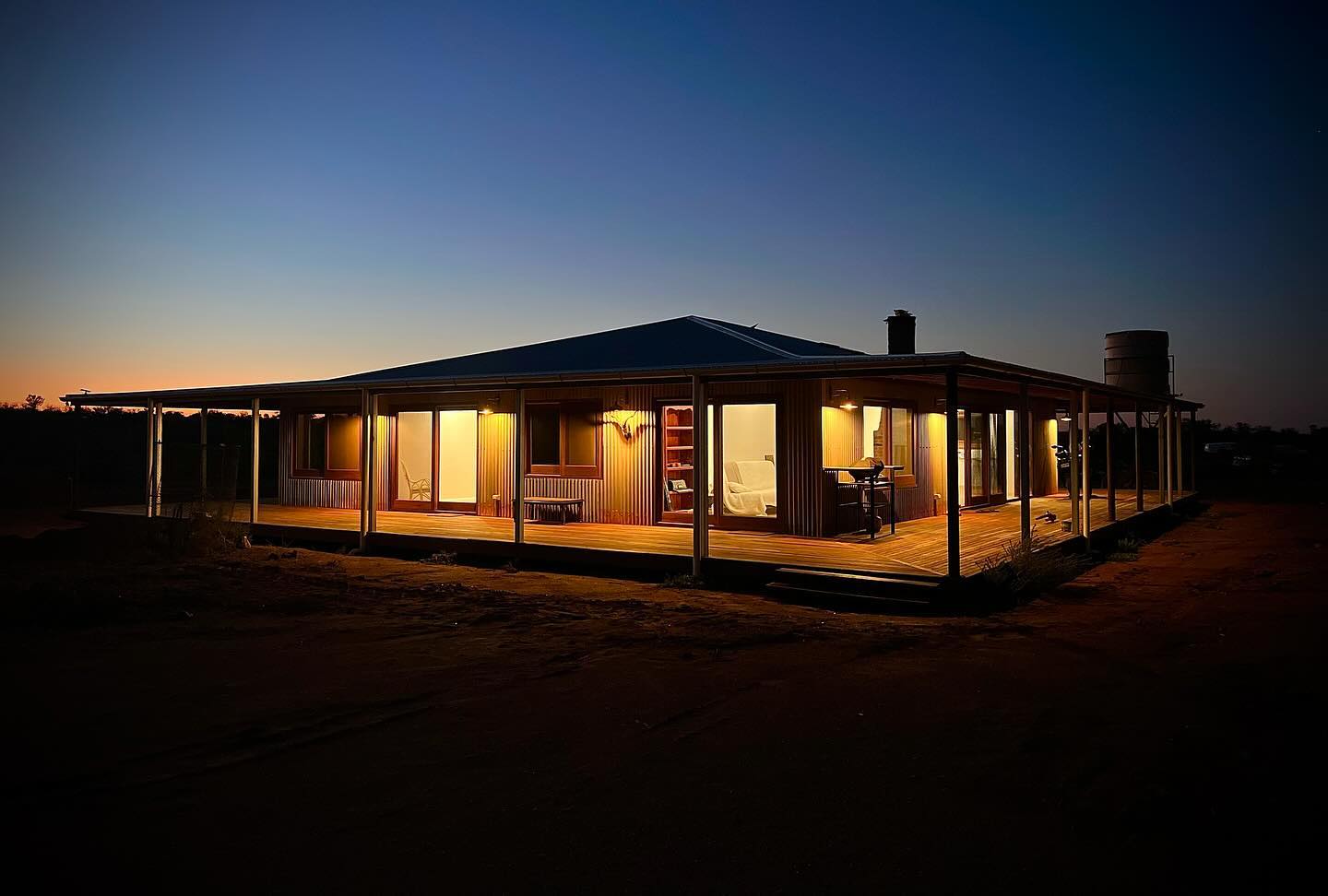 Photo of Outback Climate Smart Home lit up at night